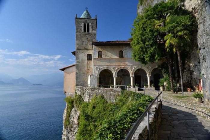 Lago Maggiore. The monastery of Santa Caterina del Sasso built on a cliff flank, hanging above the waters of Lago Maggiore, province of Varese, Italy. Northern Italian lakes.