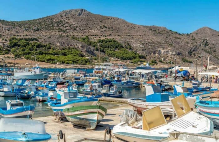 The Port of Favignana island, is the largest of the three Aegadian islands in the Mediterranean sea. Background, blue.