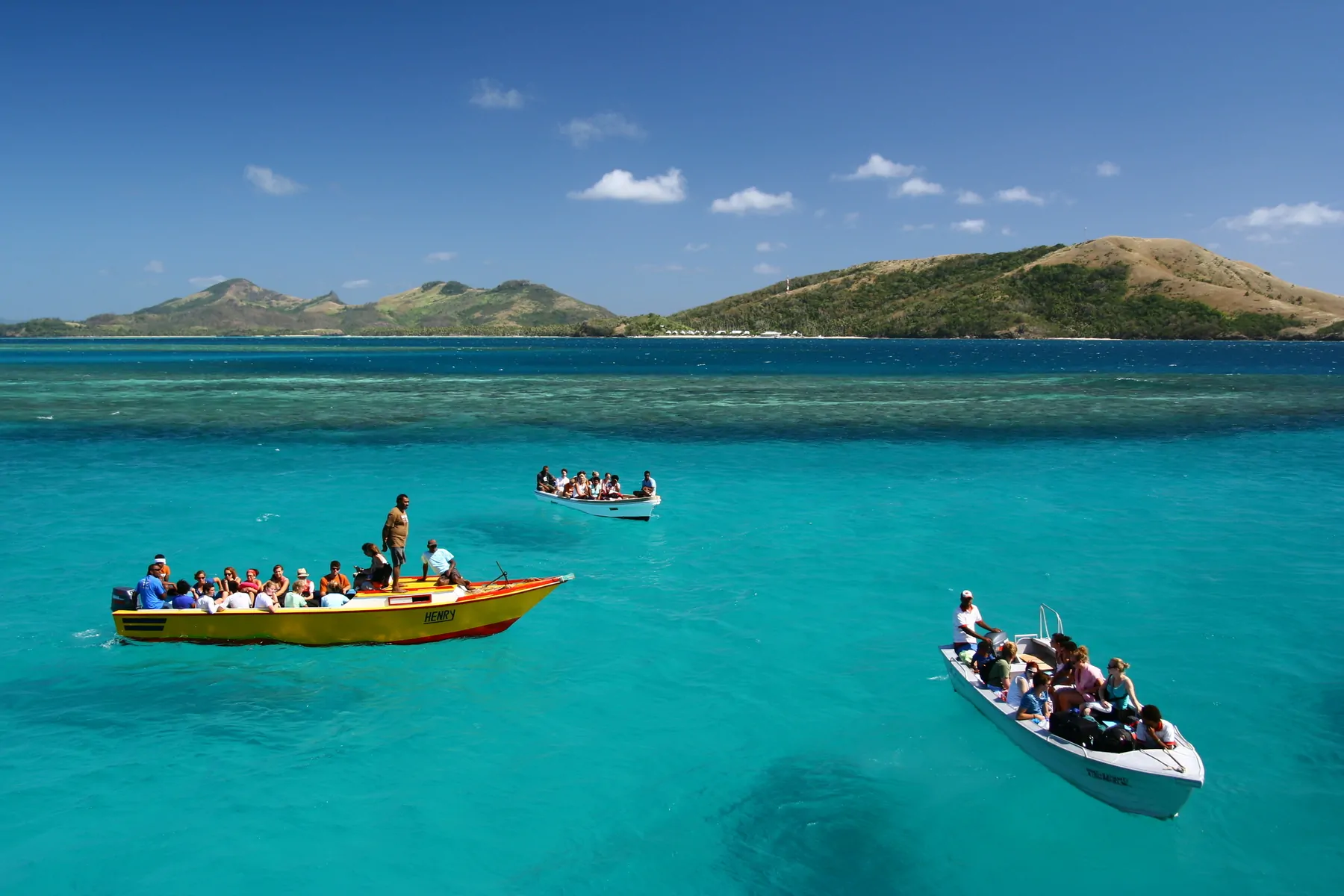 Fiji boat hover on turquiose water