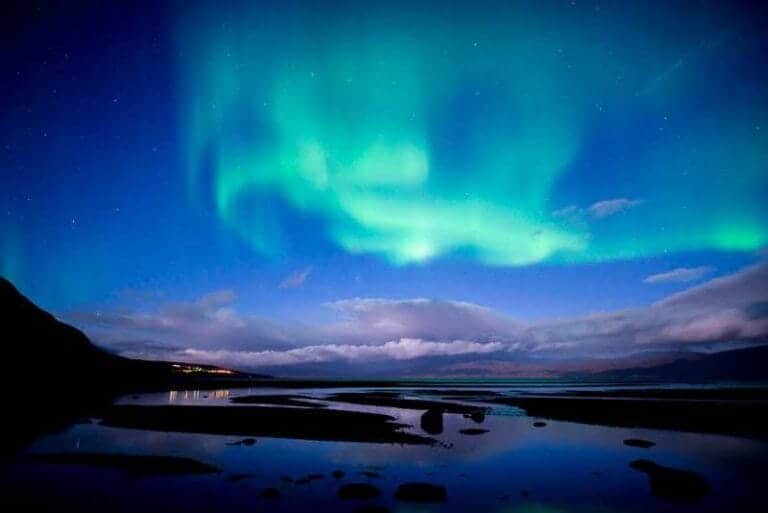 Lapland, Northern lights dancing over calm lake in Abisko national park in Sweden