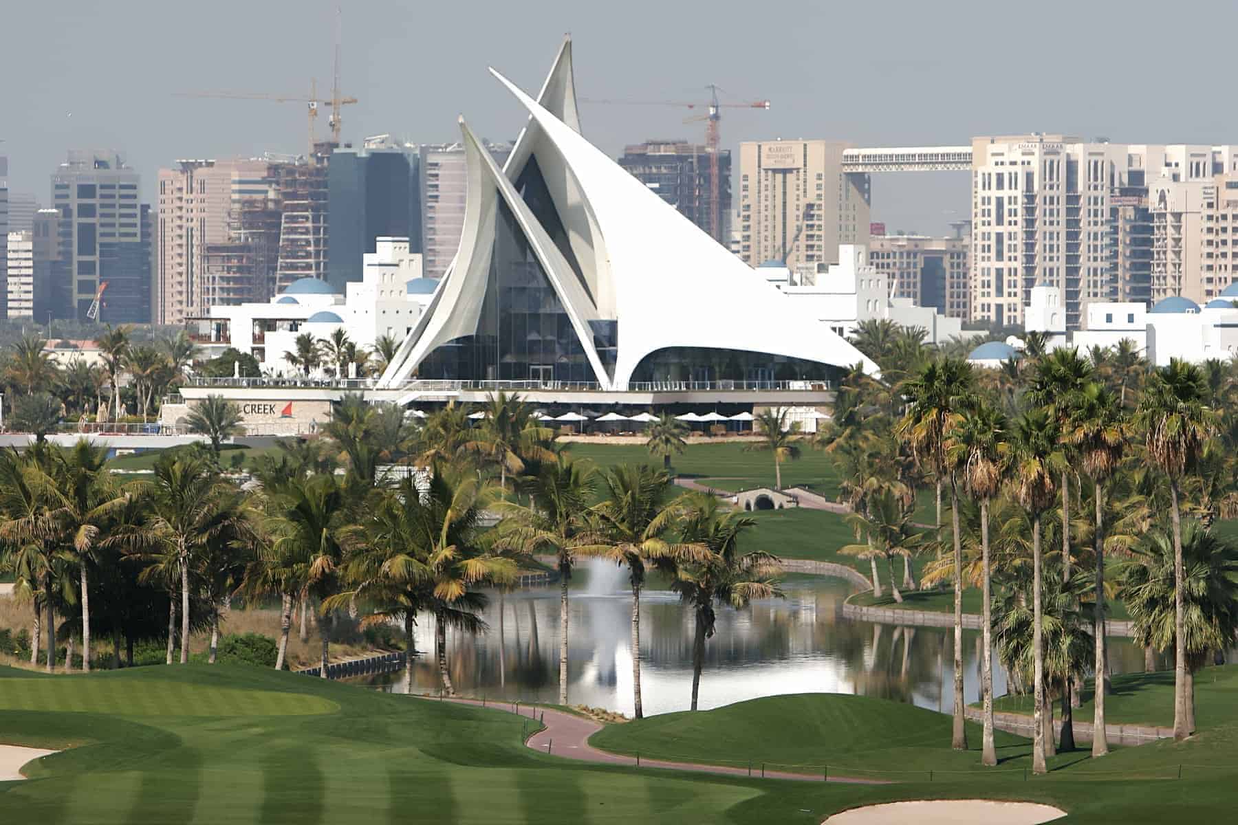 Green golf court with palms and lakes in dubai creek, united arab emirates