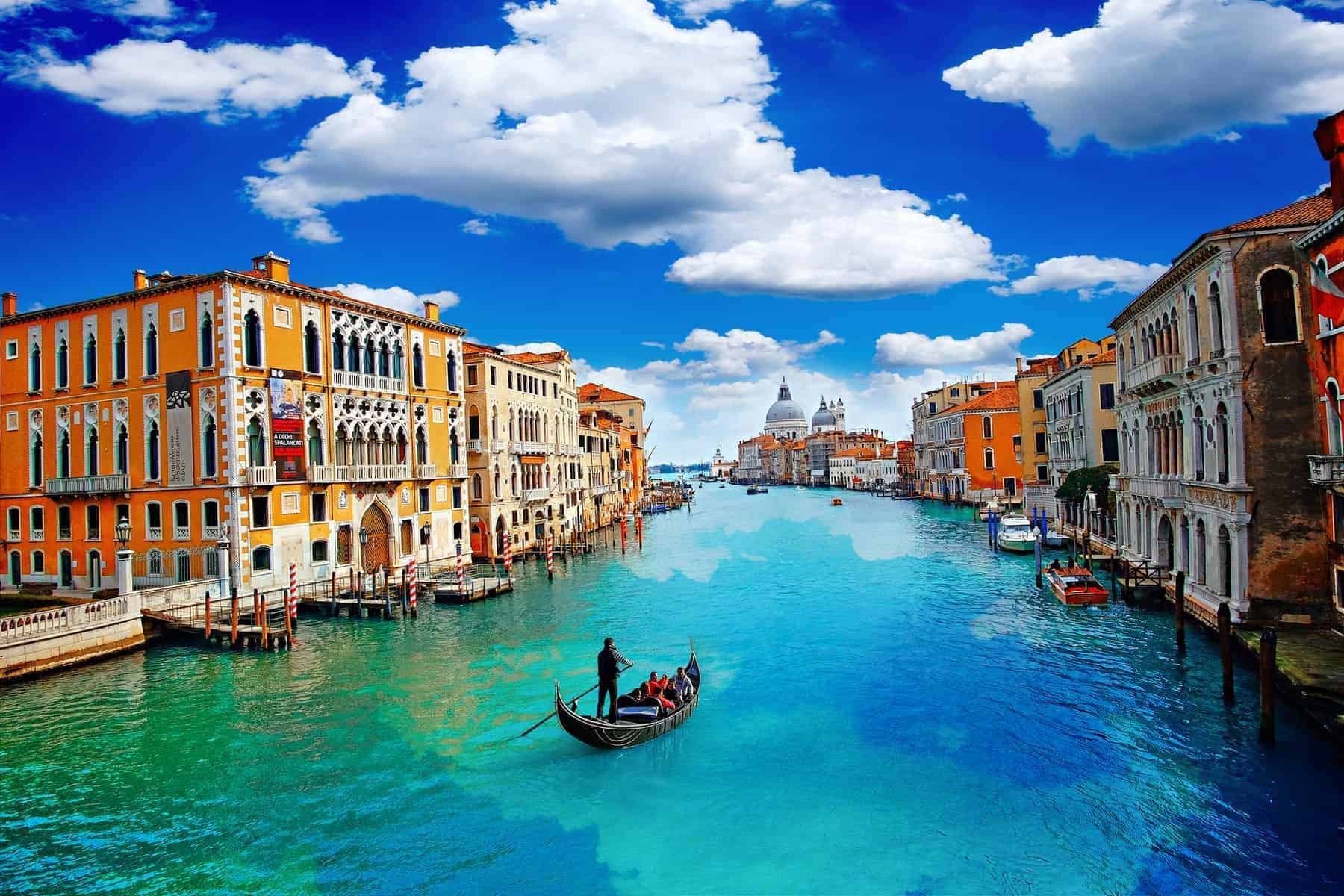 Ancient buildings and gondola along Canal Grande in Venice Italy