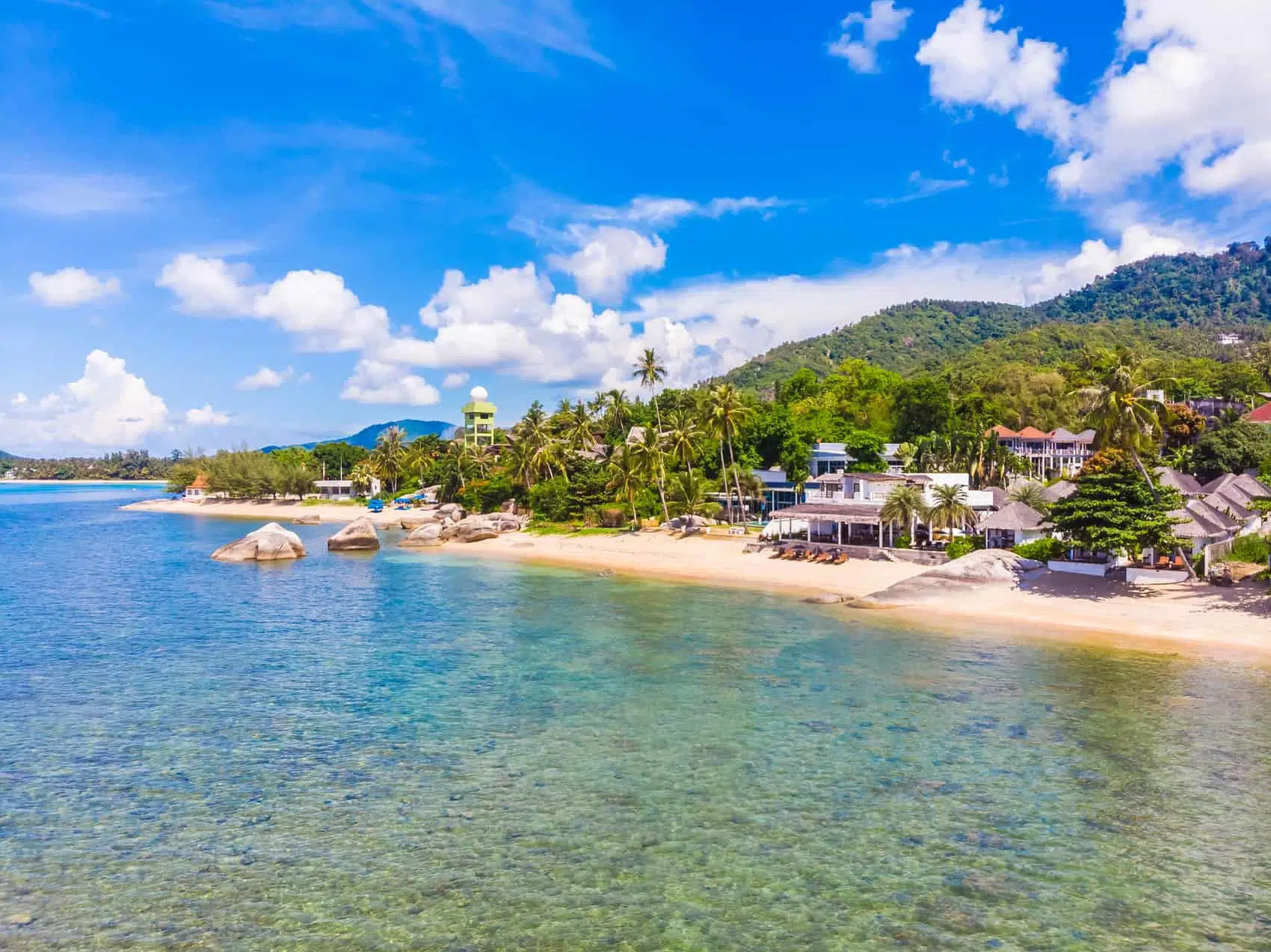 Beautiful aerial view of beach and sea with many tree and white cloud on blue sky in koh samui island for vacation and travel