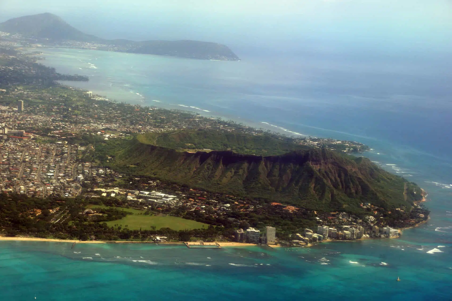 Diamondhead, Kapiolani Park, Waikiki, Natatorium, Kapahulu town, Pacific ocean, clouds, and on Oahu, Hawaii.