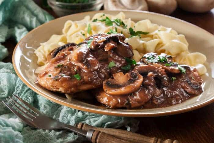 Delicious chicken marsala served with fettucine pasta. Italian cuisine