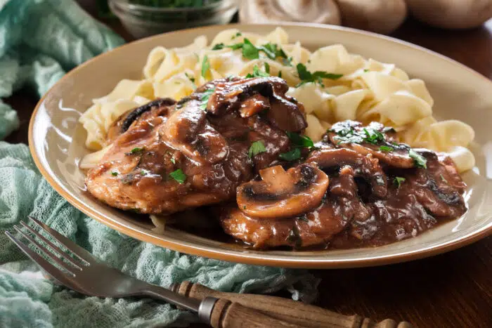 Delicious chicken marsala served with fettucine pasta. Italian cuisine