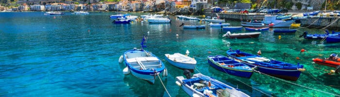Rejser til Italien. Calabrien, Scilla by, view with turquoise sea,traditional boats and houses, Italien