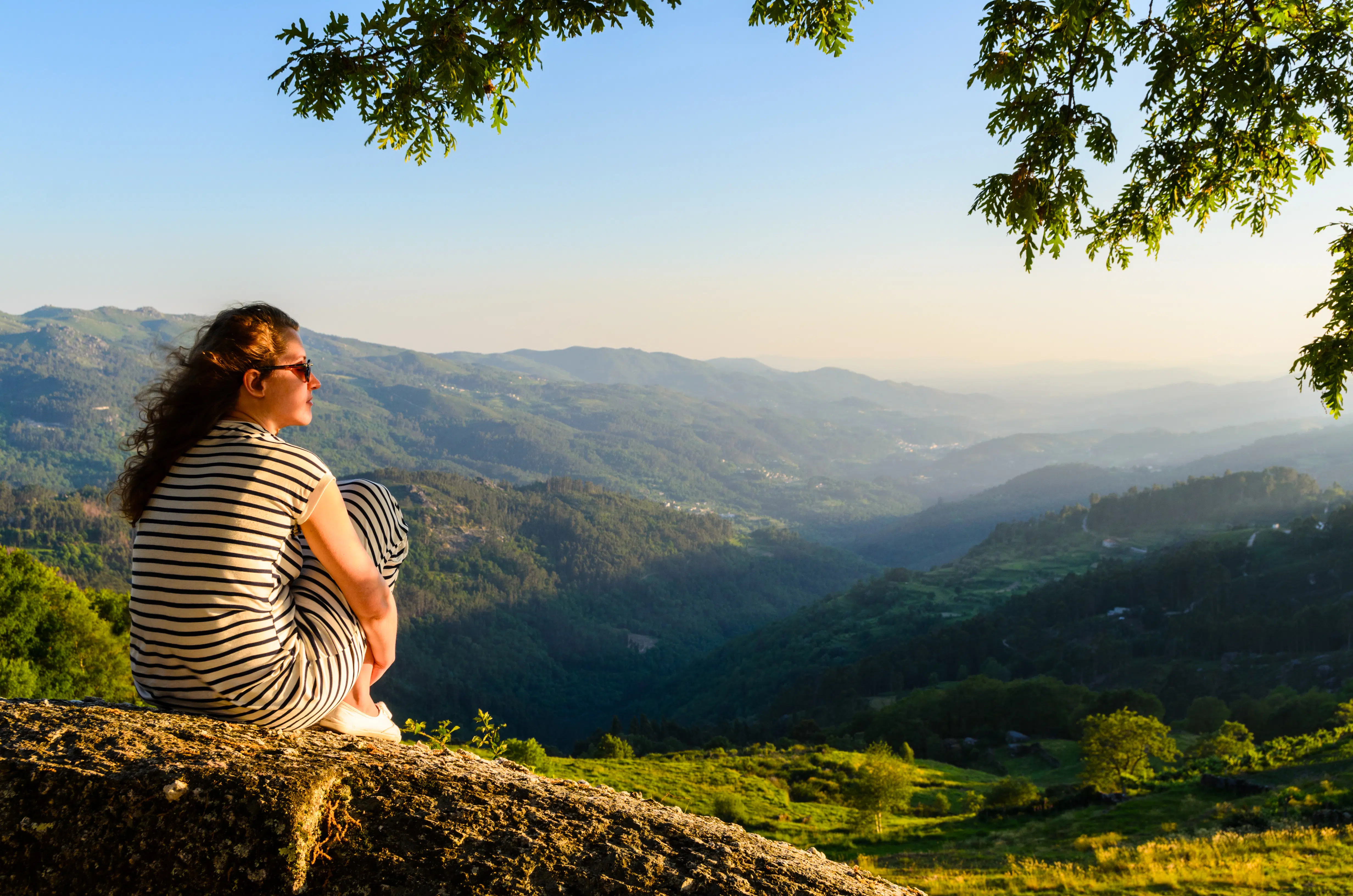 scenic view of woman watching at sunset mountains, Peneda-Geres National Park, northern Portugal.