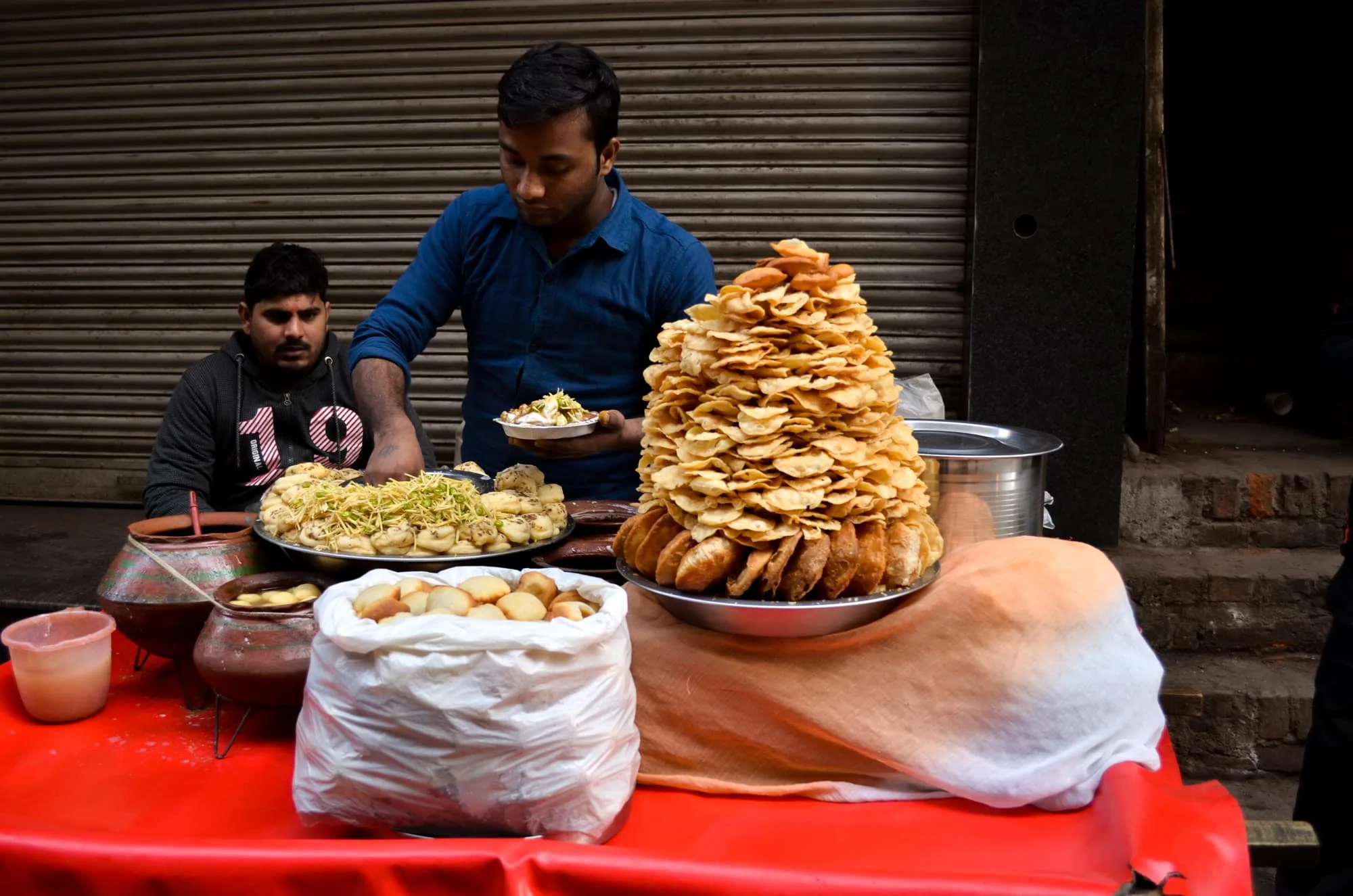 Street hawker preparing and serving famous spicy Chaat in Chandni Chowk, Old Delhi, India