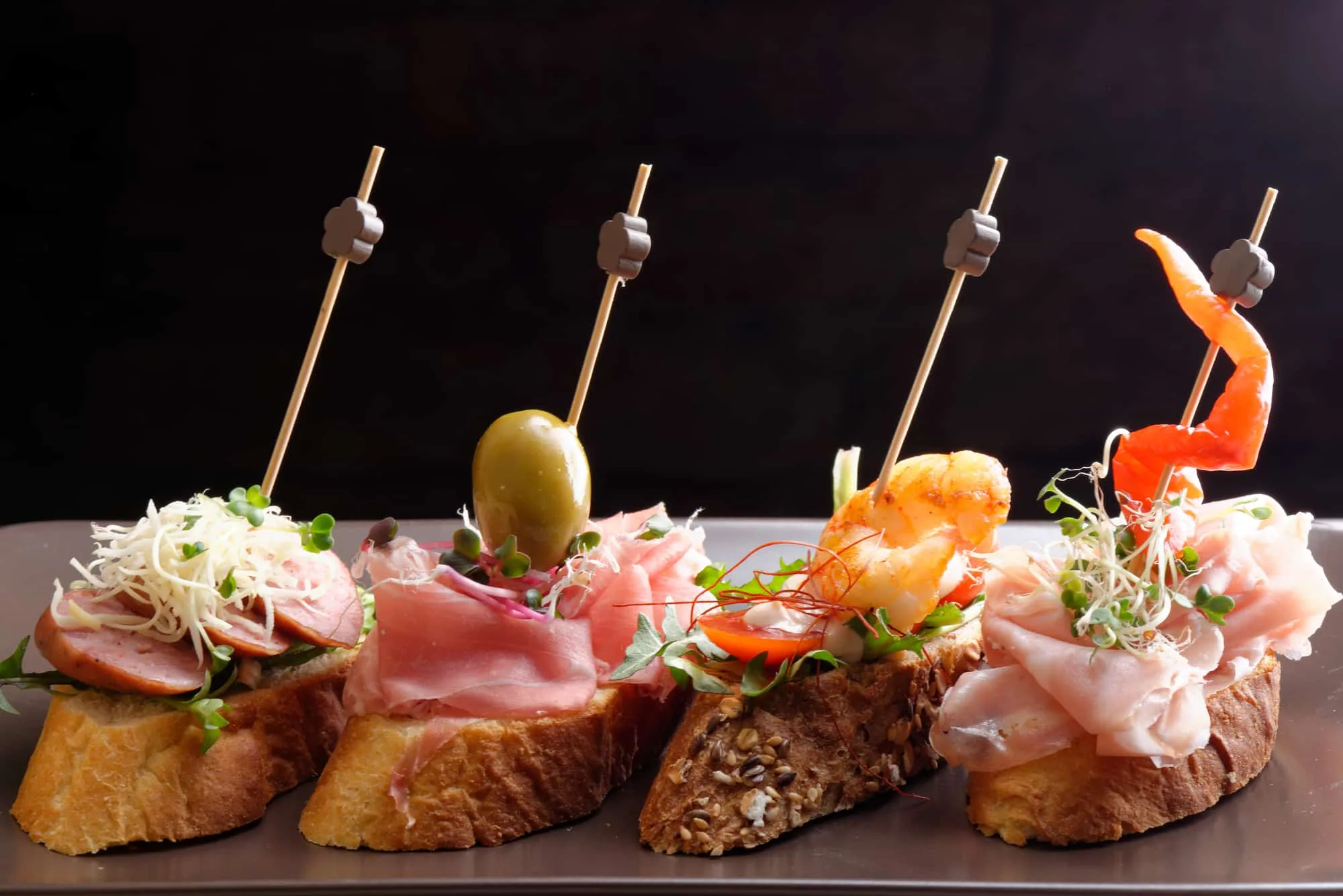 Tapas - Spanish tapas served on a sliced baguette.