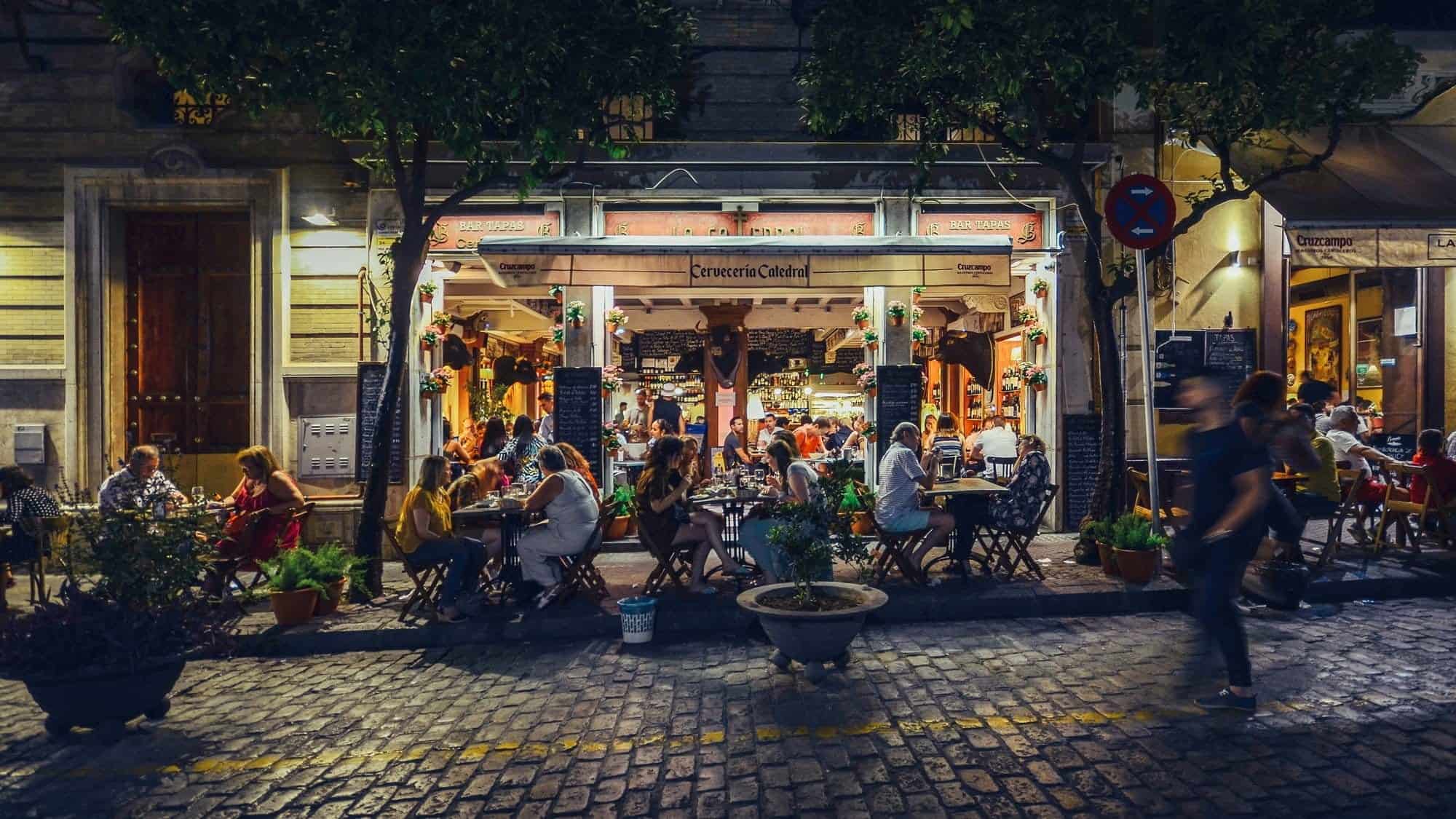 Busy bar and restaurant on Calle Mateos Gago servicing Spanish style tapas to locals and tourists well into the late hours in the historic centre of Seville