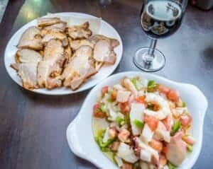 Plates of tapas and glass of red wine in Sevilla in Spain