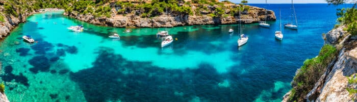 Mallorca, bay beach Cala Pi, beautiful seaside coast with boats, Balearic Islands, Spain Mediterranean Sea.