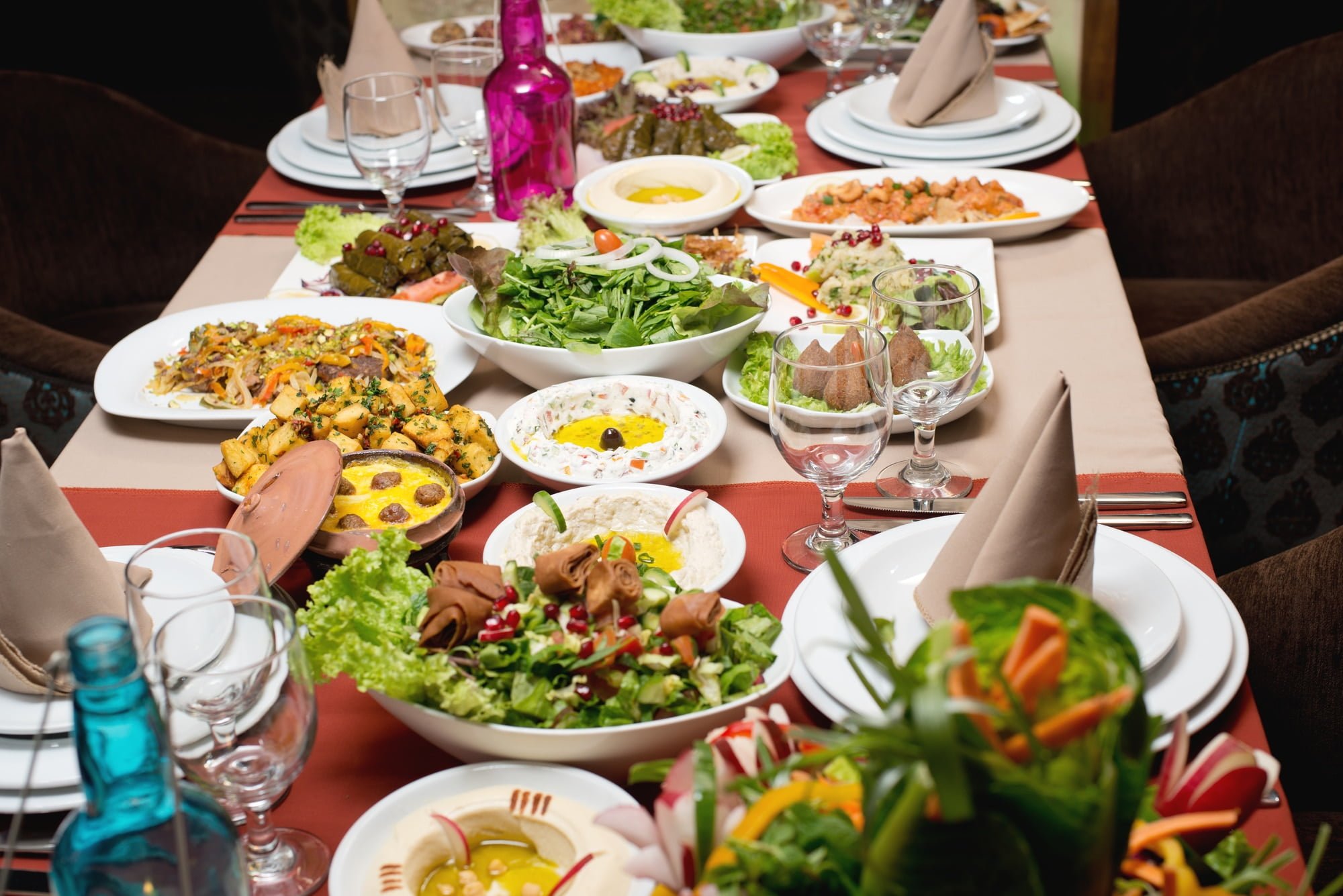 Table with various Arabic food served. Middle Eastern cuisine