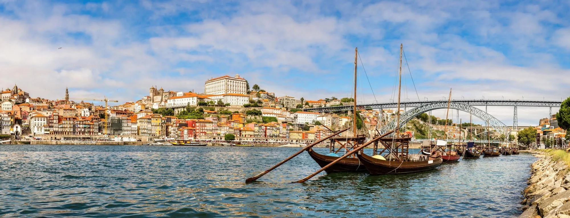 Porto and old traditional boats with wine barrels in Portugal in a summer day