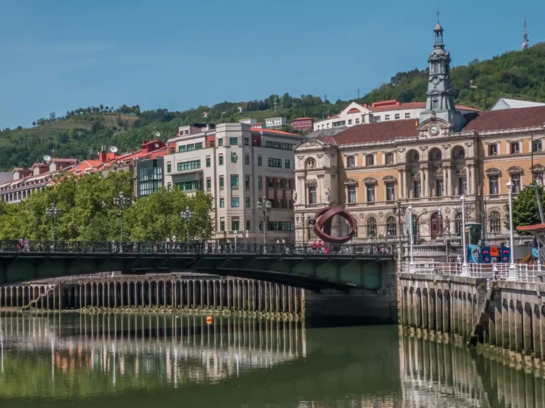 Bilbao, Spain. Bilbao municipality and a famous monument beside the river Nervion with a clear blue sky