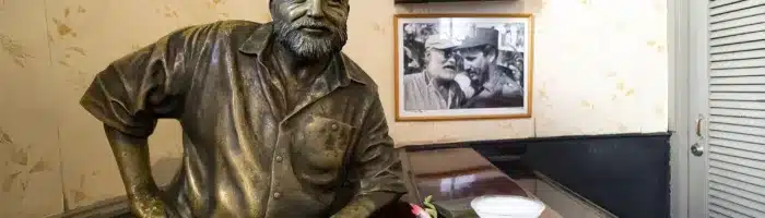 Havana, Cuba: Glass of Daiquiri cocktail and statue of American writer Ernest Hemingway in the bar El Floridita in Havanna