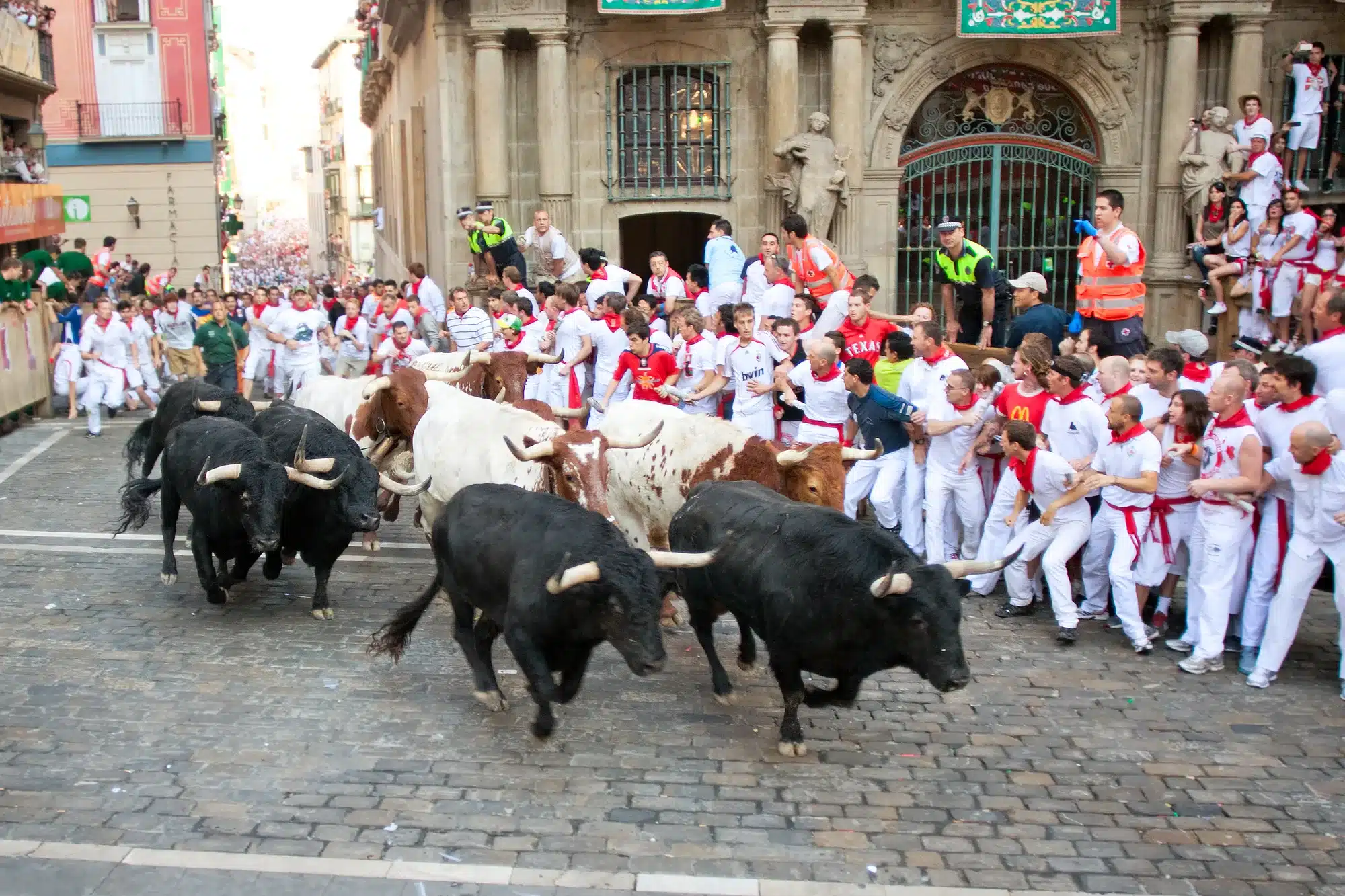 People run from bulls on street during San Fermin festival in Pamplona, Spain 