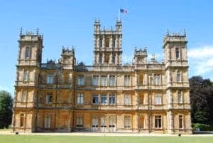 Highclere Castle is a country house in the Jacobean style, with a park designed by Capability Brown. The 5,000-acre estate is in Hampshire, England, United Kingdom, about 5 miles south of Newbury, Berkshire. It is the country seat of the Earl of Carnarvon, a branch of the Anglo-Welsh Herbert family. The architecture is reminiscent of the Houses of Parliament in London. Popular TV show Downton Abbey was largely filmed here and the tour of the castle rooms takes you into many rooms used in the series.