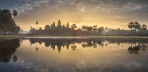 Sunrise view of popular tourist attraction ancient temple complex Angkor Wat with reflected in Lake Siem Reap, Cambodia